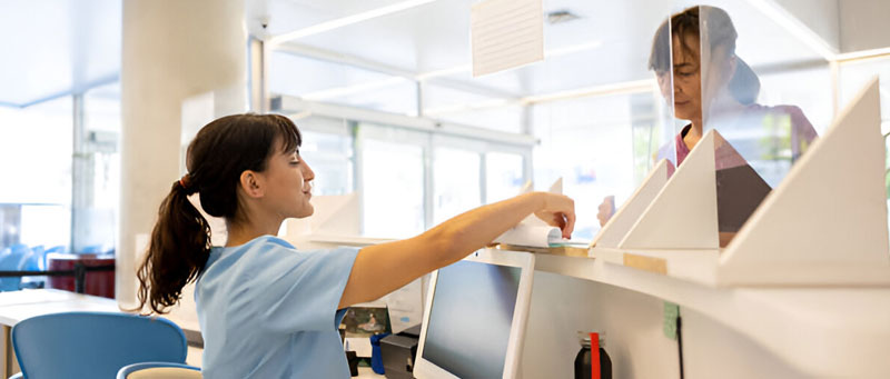 woman at computer registering for Dept of Pests Exams
